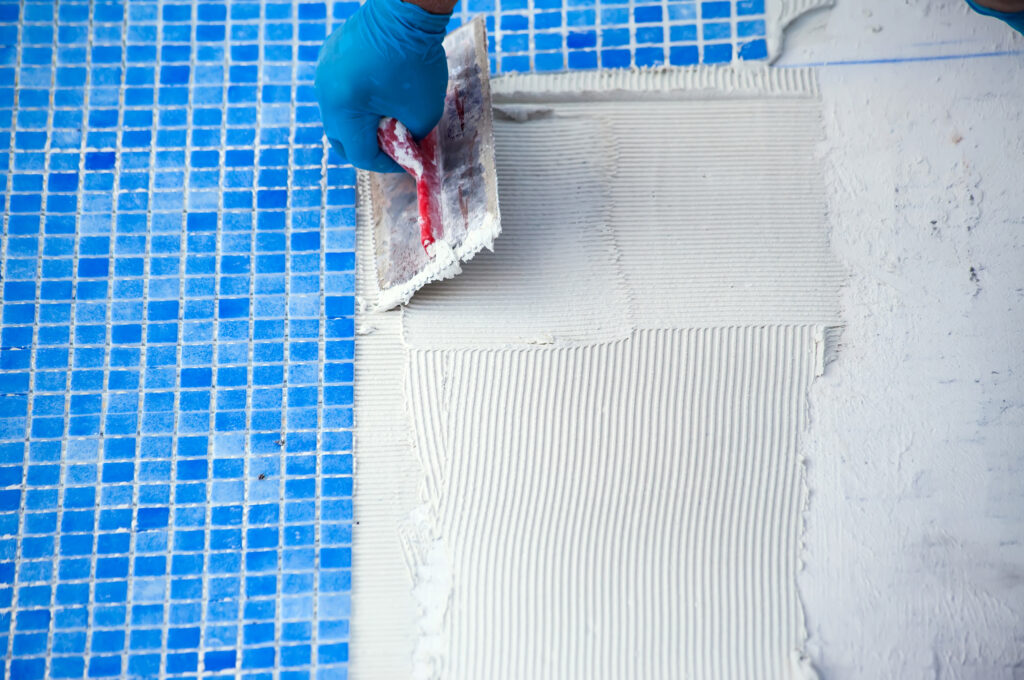 Tiling being added to a pool