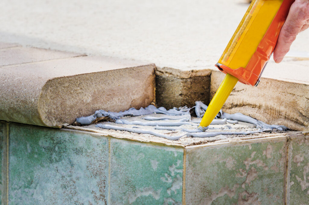 Pool Pro adding adhesive to a pool siding