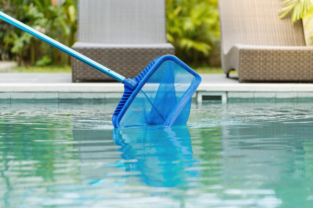 Net being dragged inside of a pool to clean it